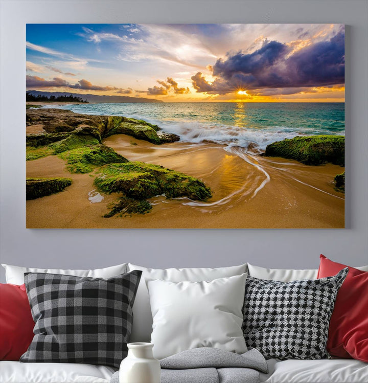 The Sunset Beach Wall Art Canvas Print is a gallery-wrapped triptych showcasing a beach scene with mossy rocks and a vibrant sunset. Made from museum-quality canvas and featuring a UV-protective coating, it elegantly provides both beauty and durability.