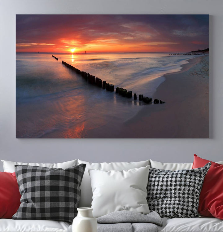 In a modern living room, the Sunset Beach Wall Art Canvas Print is displayed above. This triptych, printed on museum-quality canvas with a UV-protective coating, ensures lasting brilliance. It's ready to hang and brings an elegant touch to your space.