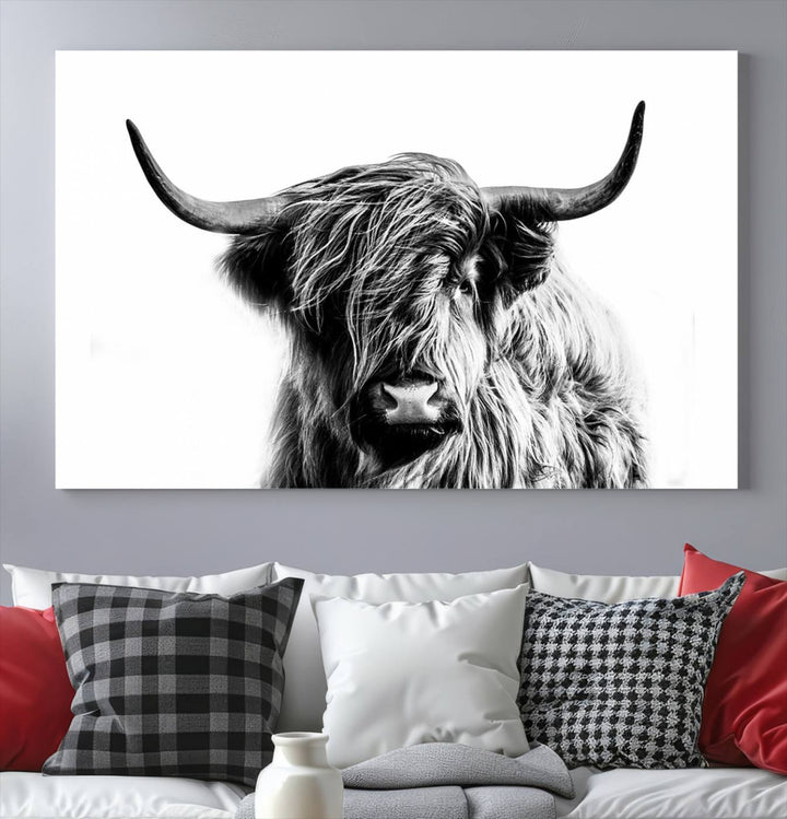 The Scottish Highland Cow Cattle Art Print Farmhouse Wall Art Canvas Print enhances rustic farmhouse decor with its depiction of a long-haired, large-horned cow. This triptych is an ideal choice for chic wall art.