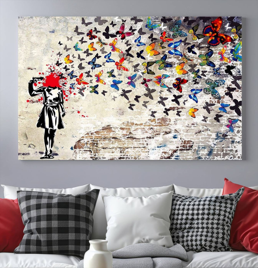 The Banksy Art Butterfly Girl Explosion Canvas showcases a dynamic figure with butterflies bursting from their head, set against a textured wall background. This vibrant urban graffiti piece is perfect for modern interiors and comes ready to hang.