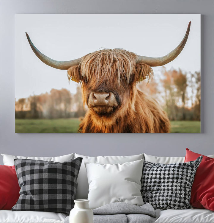 A Highland Cow Animal Scottish Cattle Art Print Farmhouse Wall Art Canvas Print hangs in the living room, adding a touch of rustic farmhouse decor.