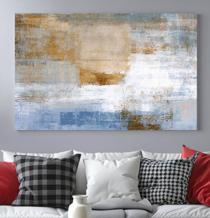 The Blue Multi Panel Abstract Wall Art Canvas Print, featuring an elegant blend of blue, beige, and brown tones, hangs gracefully on the wall, adding a contemporary touch to the space.