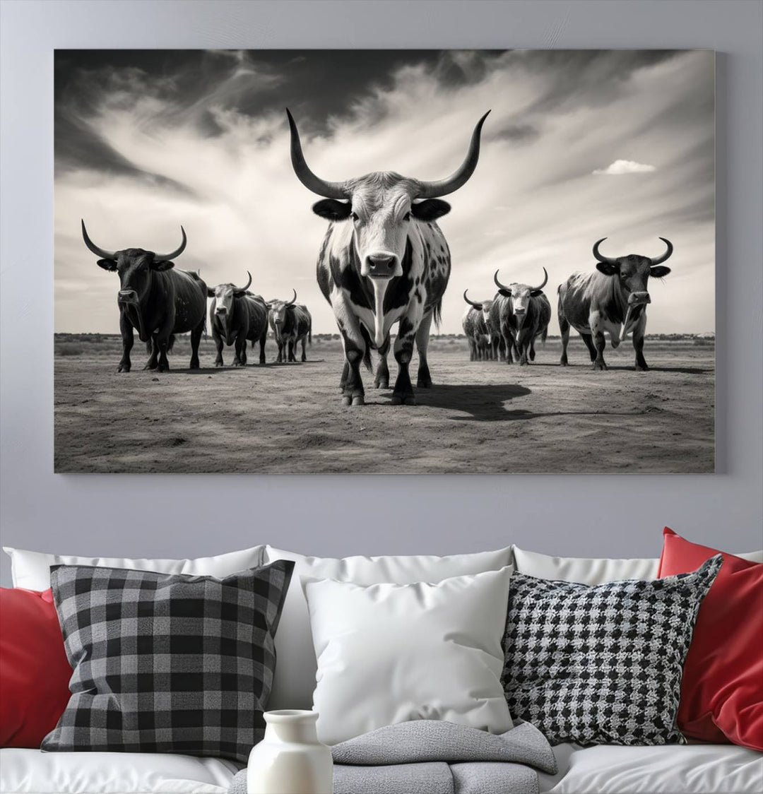 The Black and White Longhorn Cattle Wall Art, featuring a three-panel display of cowboy Western longhorns walking toward the viewer, enhances your space with its striking presence, adding a touch of Western decor.