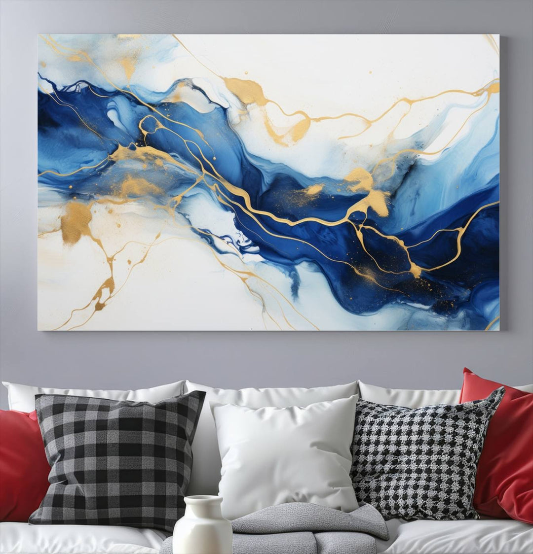 The Blue Abstract Wall Art is displayed as a triptych on museum-quality canvas, showcasing a blue and gold abstract design. The artwork includes a UV-protective coating to maintain its vibrancy and comes with the benefit of free shipping.