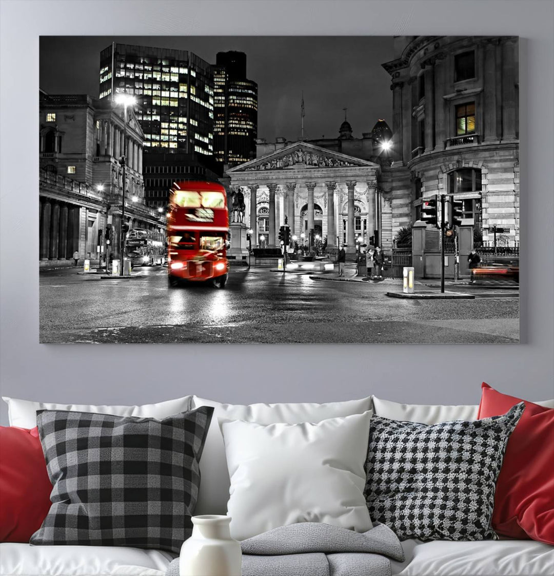 The London Night Red Bus Wall Art Canvas Print features a black and white cityscape with a moving red double-decker bus, crafted on museum-quality canvas with a UV-protective coating. This ready-to-hang artwork is designed to stand out and enhance any space.