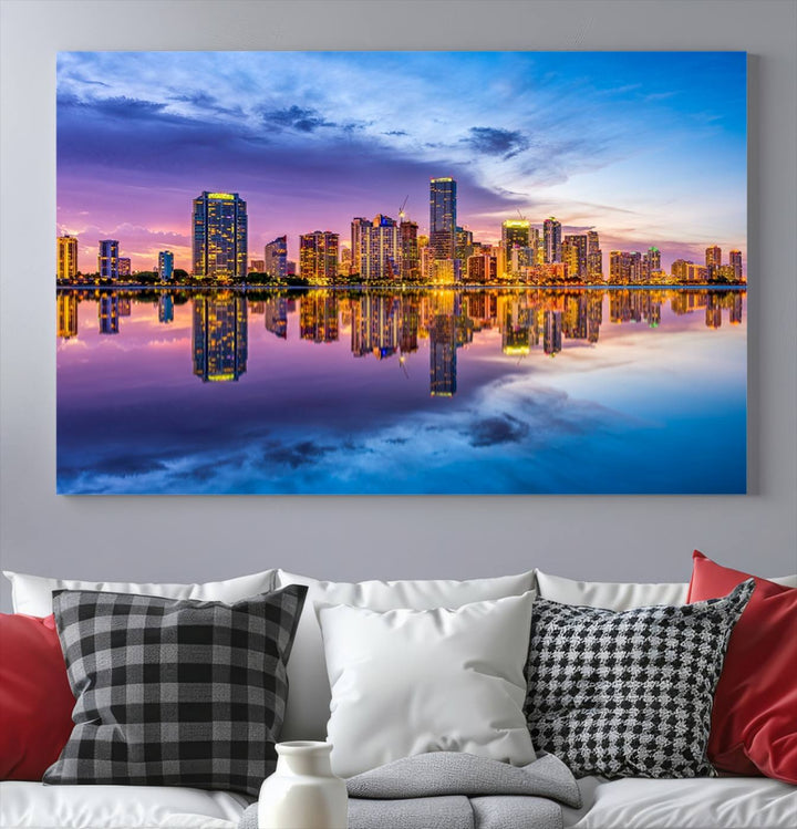 The Miami City Wall Art Canvas Print, featuring a three-panel depiction of a city skyline at sunset reflected in water, beautifully enhances the wall. Made with museum-quality canvas and a UV-protective coating, it comes ready to hang.