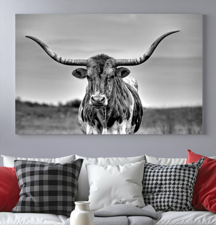 The Texas Longhorn Cow Wall Art, featuring a black and white image of a longhorn bull on canvas, brings charm to the room with its sophisticated appeal.