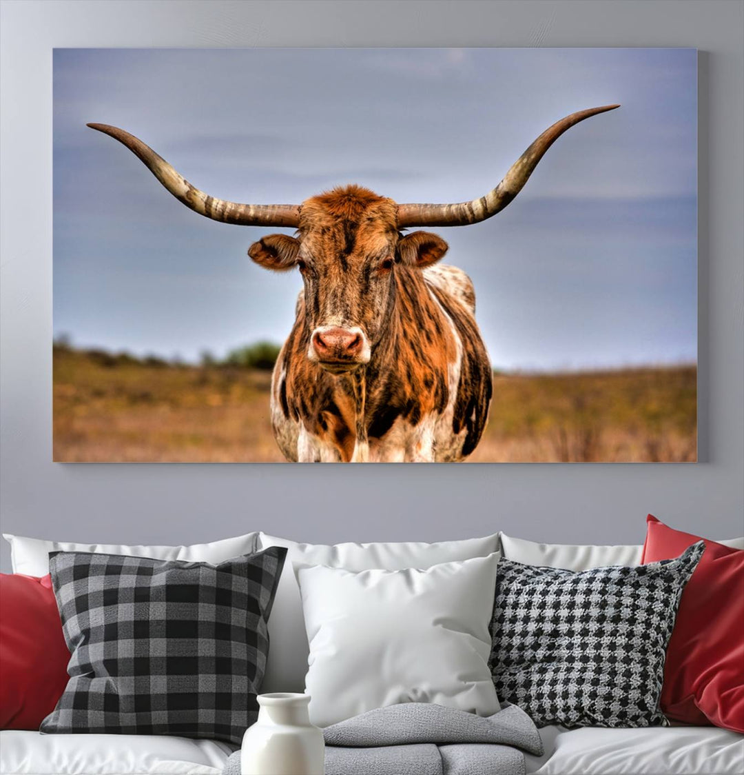 The Texas Longhorn Wall Art Print, a triptych canvas artwork depicting a longhorn bull in a field, features a gallery-quality finish.