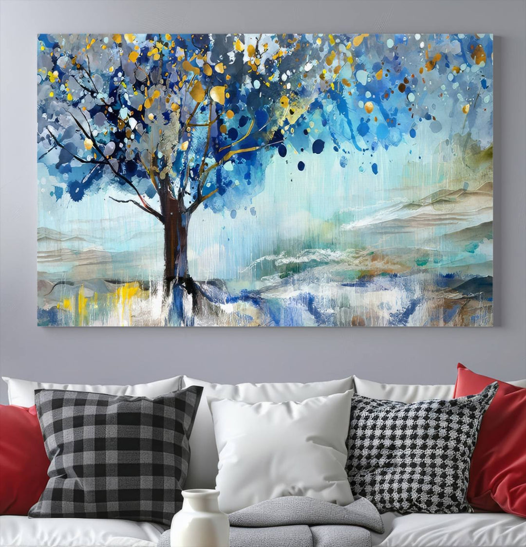 A modern living room features a three-panel Watercolor Style Abstract Tree Printing Wall Art Canvas in vibrant blue and yellow, crafted on museum-quality material.