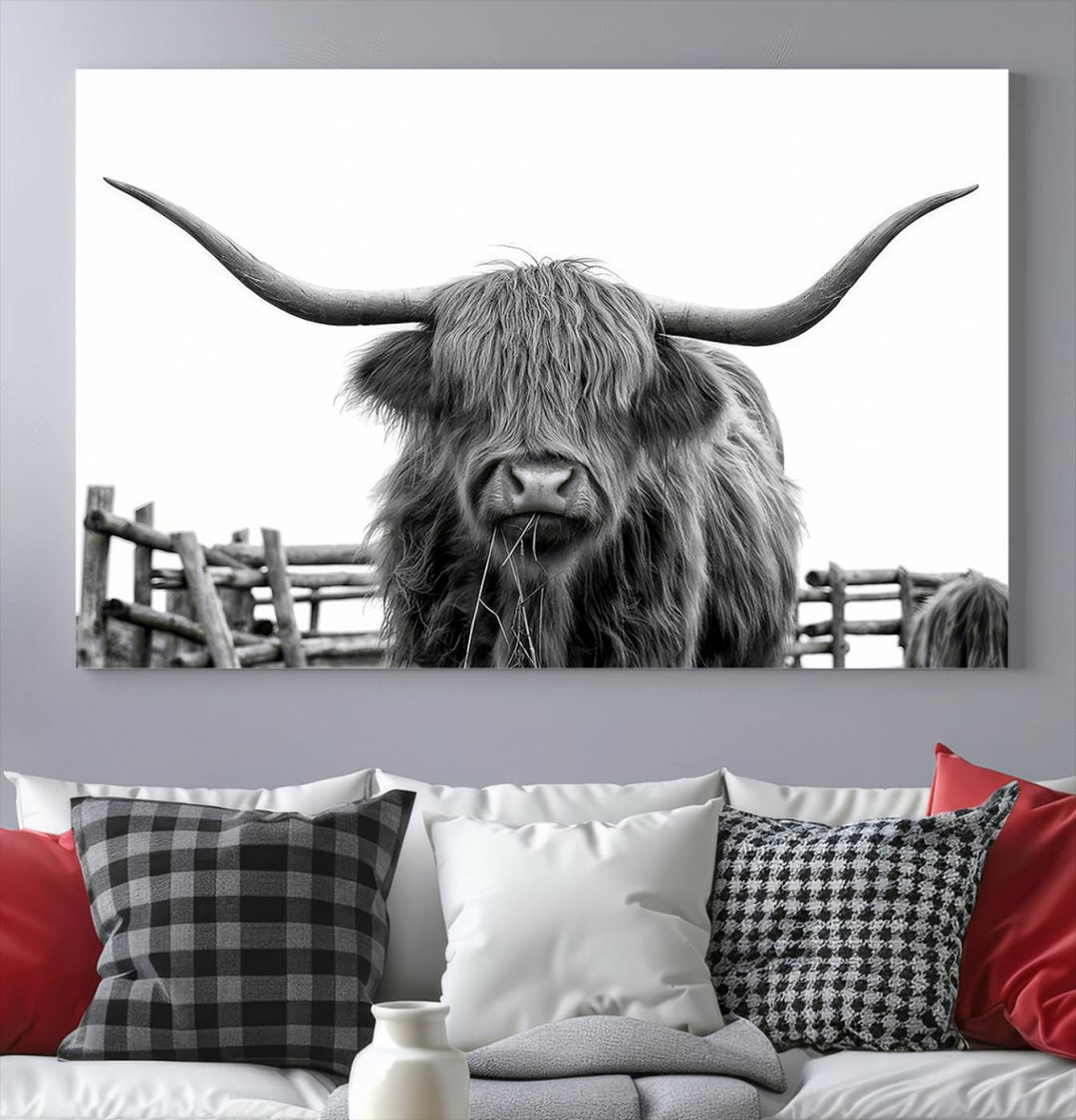 The Longhorn Canvas Print, featuring a black-and-white triptych of a Bighorn cow with shaggy fur and impressive long horns, is elegantly showcased. This wall art piece boasts a gallery-quality finish on premium canvas, bringing sophistication to any room.