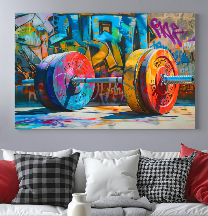 The Fitness Gym Barbell Graffiti Wall Art Canvas Print, a vibrant triptych featuring a barbell against a graffiti backdrop, elegantly hangs in the room. Crafted on premium canvas with a gallery-quality finish, this stunning piece of wall art effortlessly combines urban flair with sophisticated decor.