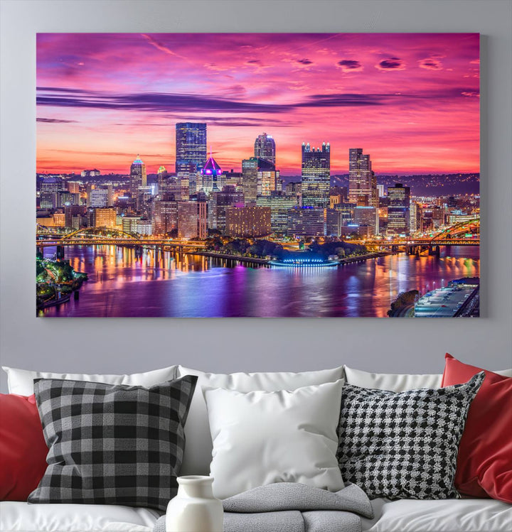 The Pittsburg Wall Art Canvas Print, showcasing a vibrant sunset glow over the city skyline and crafted by a professional artisan, adorns the space.