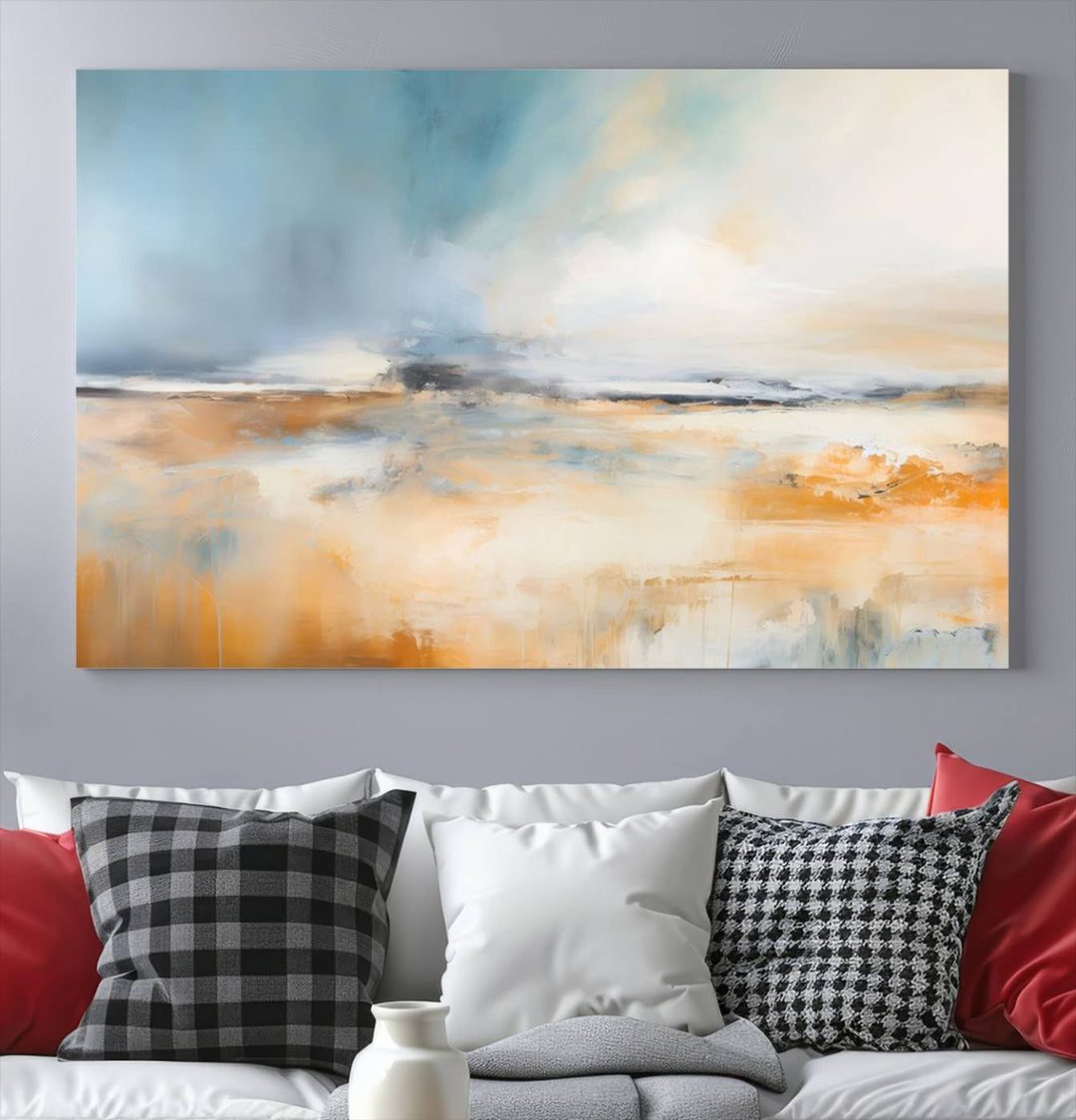 The Abstract Landscape Wall Art Canvas Print, featuring warm tones of orange and blue, is displayed on a dark wall.