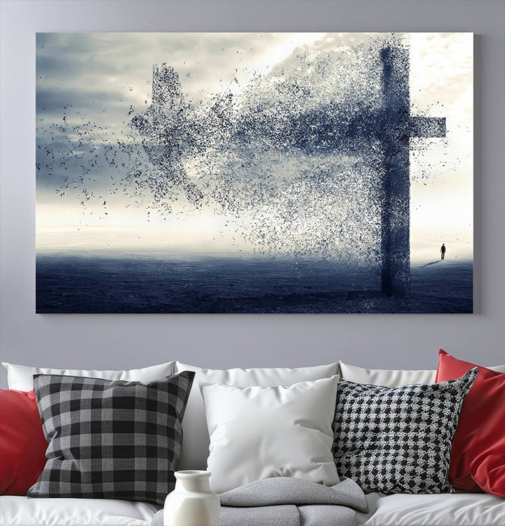 The "Jesus and the Fading Cross – Symbol of Faith" framed canvas print beautifully depicts a cross formed by birds against a moody sky above an ocean. This piece of Christian wall art infuses spirituality into the minimalist space.