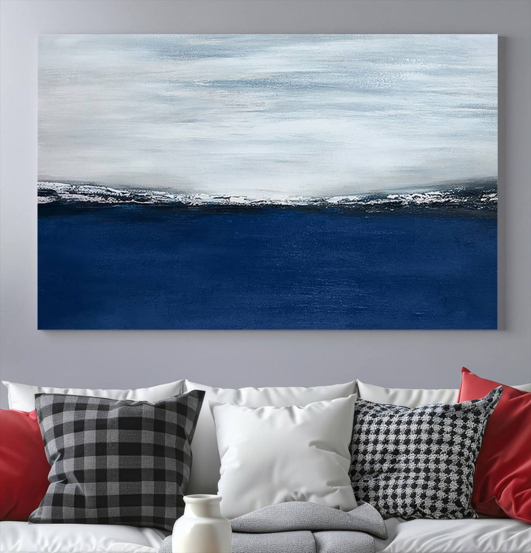 The modern living room is enhanced by the Navy Blue Abstract Wall Art Canvas Print on the wall, crafted as handmade wall art with a gallery-quality finish.