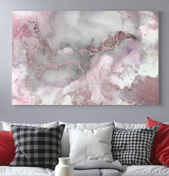 The Rose Marble Abstract Wall Art Canvas Print is a stunning triptych that showcases pink and gray tones, elegantly presented on a dark wall.