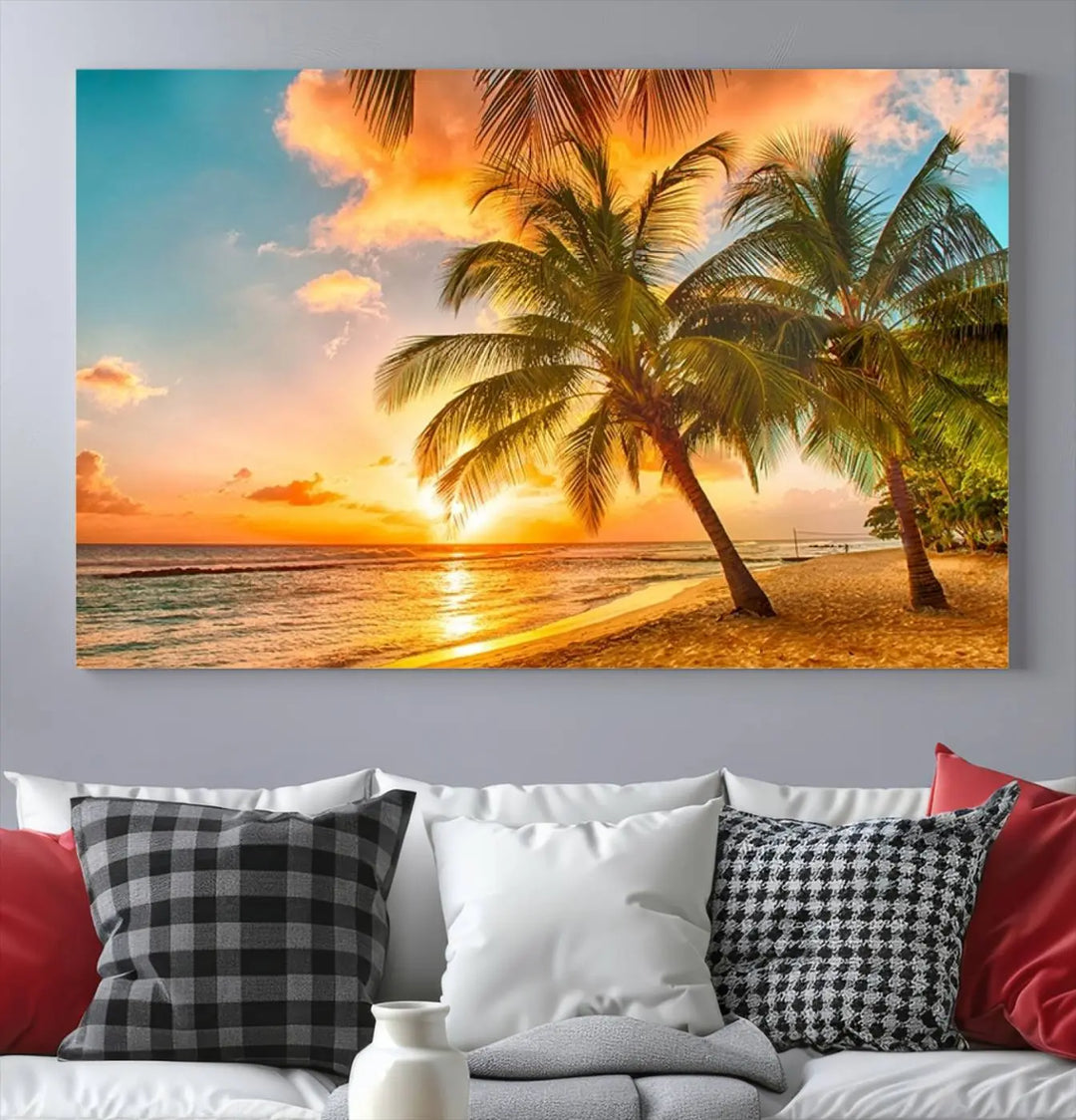 The Tropical Sunset Wall Art Print features a vibrant beach scene with palm trees and an ocean view highlighted by a golden sunset.