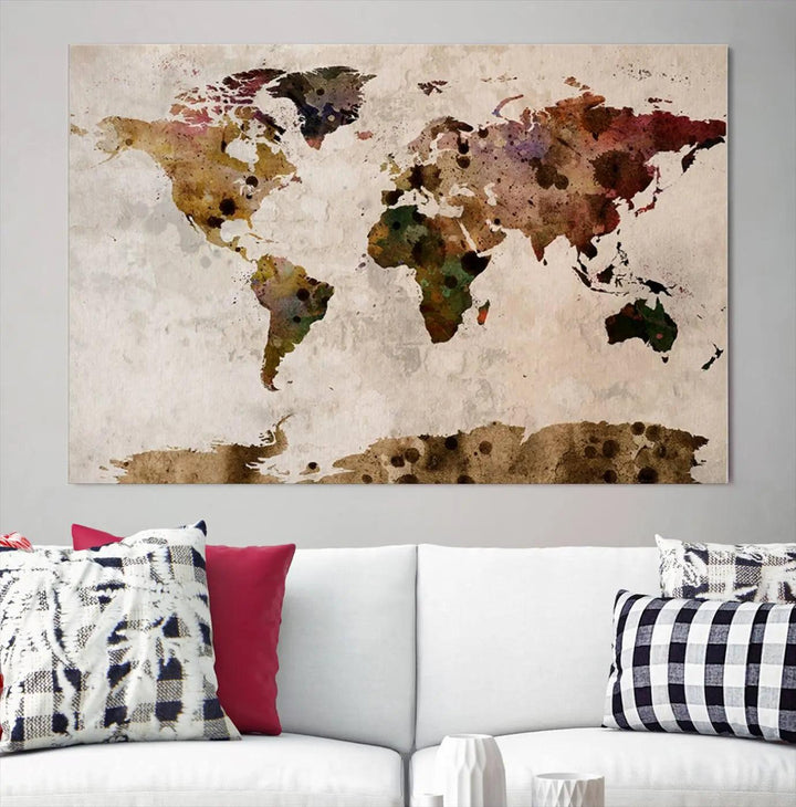 A Watercolor World Map Canvas Print, wrapped in an elegant gallery style, hangs on the wall.