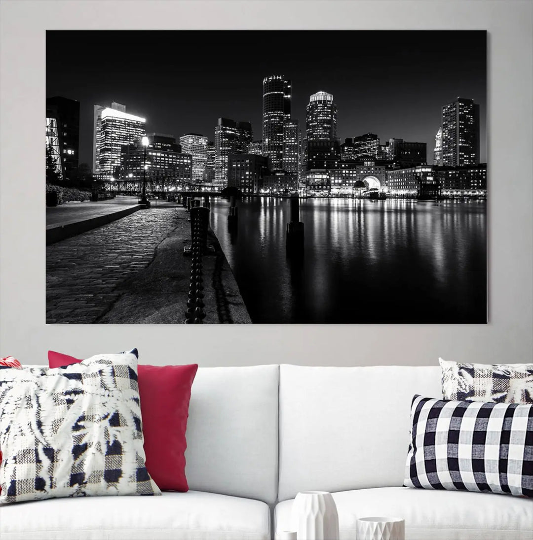 The Boston City Lights Skyline Black and White Wall Art Cityscape Canvas Print portrays a triptych of the city skyline at night reflecting on a calm river. This museum-quality canvas features UV-protective finishes to preserve its timeless allure.