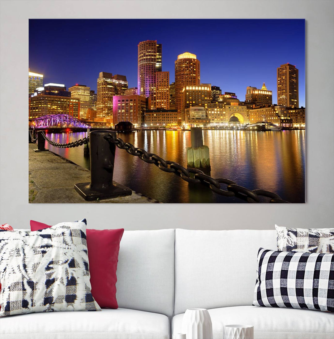 The "Boston City Night Skyline Cityscape View Wall Art Canvas Print" beautifully portrays a stunning triptych of a city skyline illuminated against the night sky, elegantly reflected in the river below. These museum-quality canvases are gallery wrapped to ensure an elegant presentation that enhances any space.