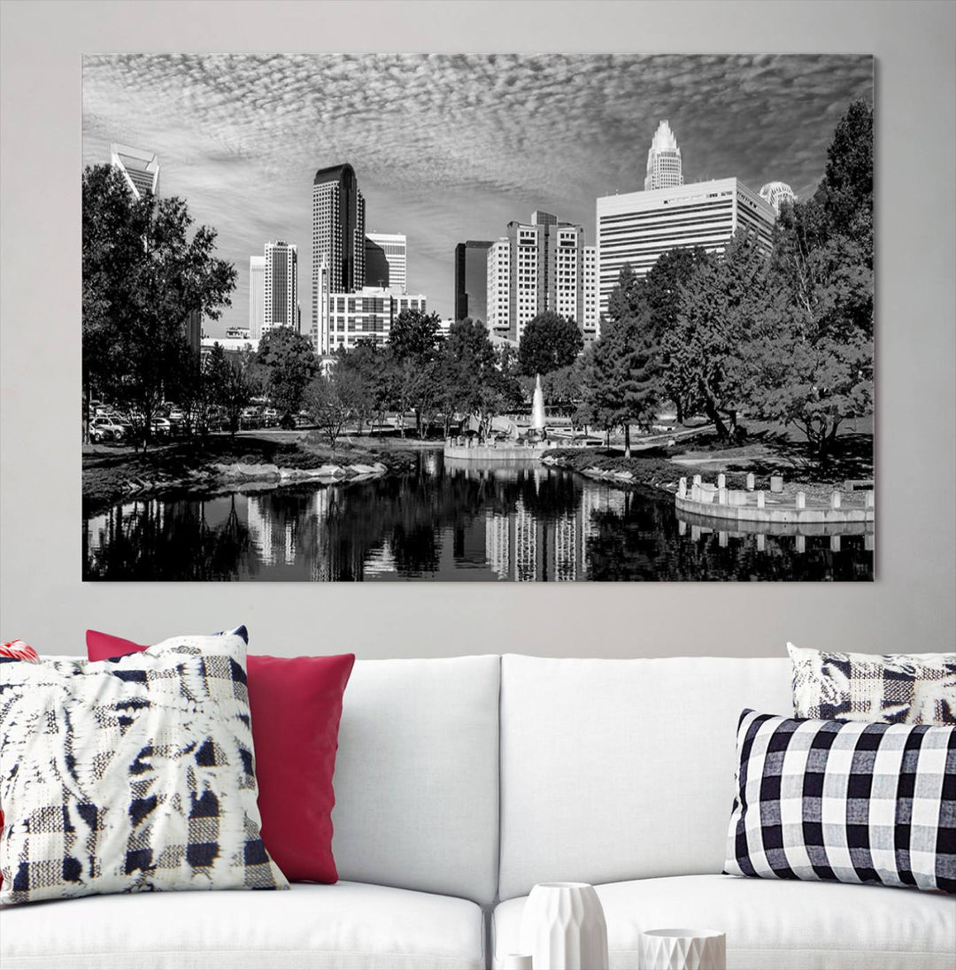 The living room features a captivating triptych titled "Charlotte City Cloudy Skyline Black and White Wall Art Cityscape Canvas Print," crafted on museum-quality canvas with UV-protective coating. Modern decor accentuates the dynamic scene.