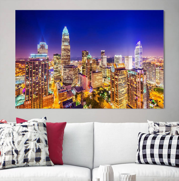 A modern living room features the Charlotte City Lights Night Blue Skyline Cityscape View wall art canvas print.