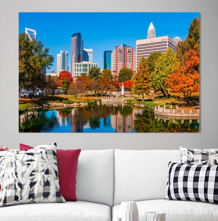 The Charlotte City Park at Fall Skyline Cityscape View wall art canvas print features a city panorama with a park and lake accented by autumn trees. It is mounted on museum-quality canvas with UV-protective coating and decorates the space.