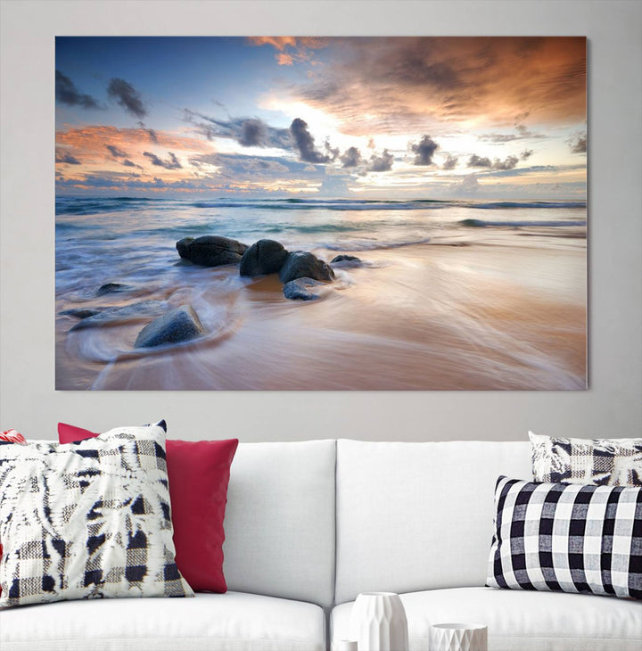 The "Serene Weather On The Beach Wall Art Canvas Print," featuring a tranquil beach scene with rocks and waves, is ready to hang and enjoy.