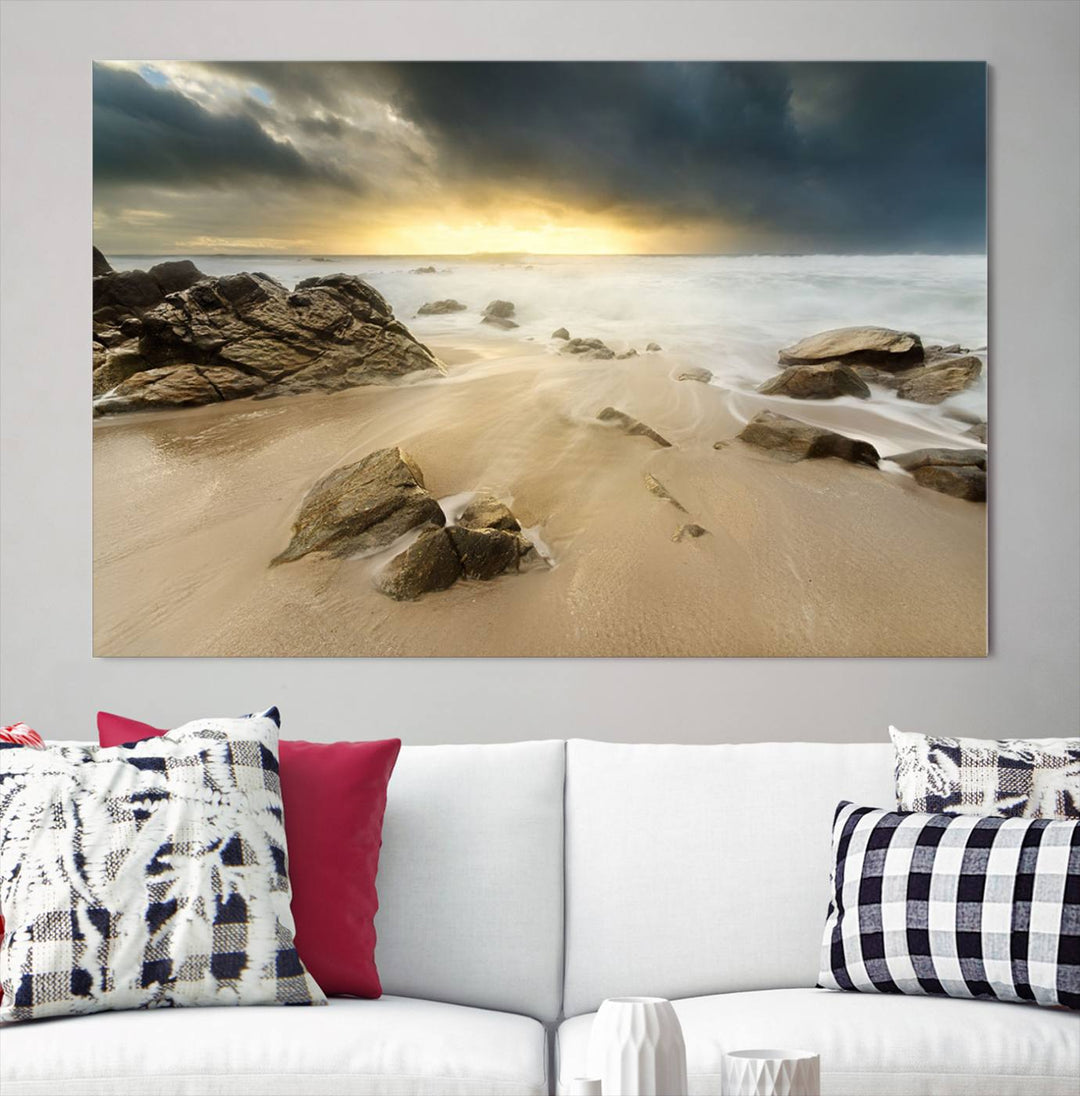 A gallery-wrapped, three-panel artwork titled "Rocks and Waves Wall Art Canvas Print" depicts a rocky beach at sunset. Each canvas showcases museum-quality craftsmanship and a UV-protective coating to maintain its vibrant colors.