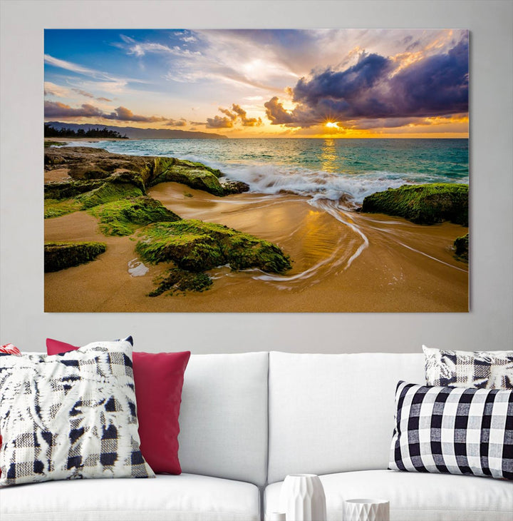 The Sunset Beach Wall Art Canvas Print is a gallery-wrapped triptych showcasing a beach scene with mossy rocks and a vibrant sunset. Made from museum-quality canvas and featuring a UV-protective coating, it elegantly provides both beauty and durability.