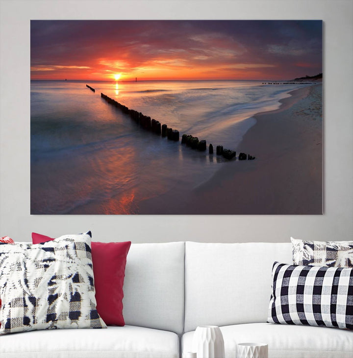 In a modern living room, the Sunset Beach Wall Art Canvas Print is displayed above. This triptych, printed on museum-quality canvas with a UV-protective coating, ensures lasting brilliance. It's ready to hang and brings an elegant touch to your space.