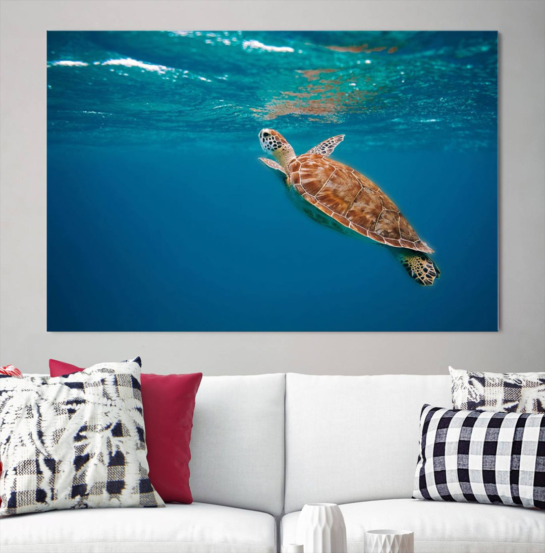 The living room features the "Baby Turtle in Ocean" wall art canvas print. This gallery-quality piece, depicting a sea turtle swimming underwater, adds an elegant touch to the space.