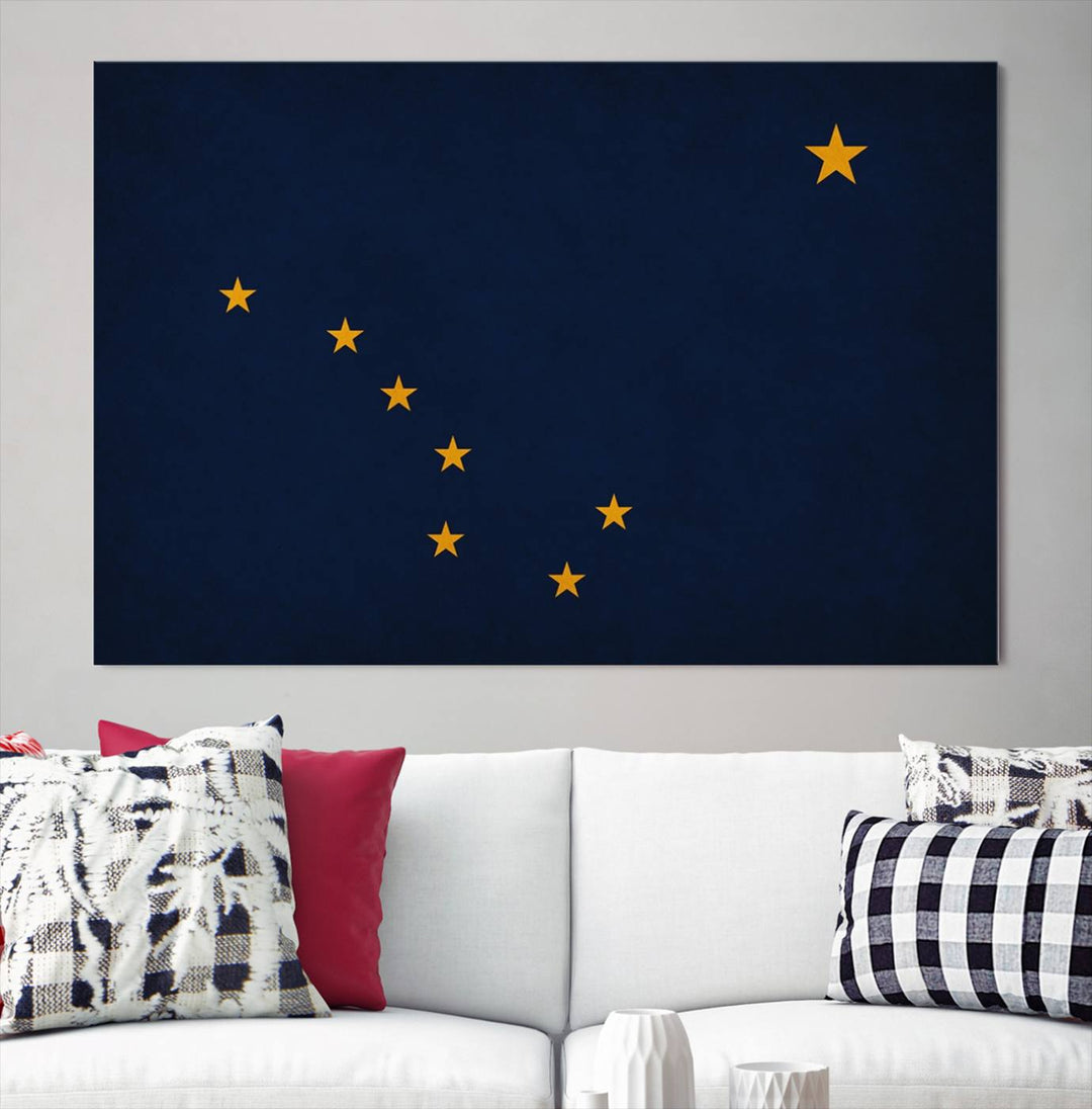 A contemporary living room featuring a triptych artwork of stars on a navy background, accentuated by the striking Alaska States Flag Wall Art Canvas Print.