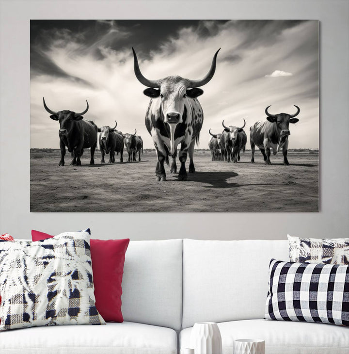 The Black and White Longhorn Cattle Wall Art, featuring a three-panel display of cowboy Western longhorns walking toward the viewer, enhances your space with its striking presence, adding a touch of Western decor.