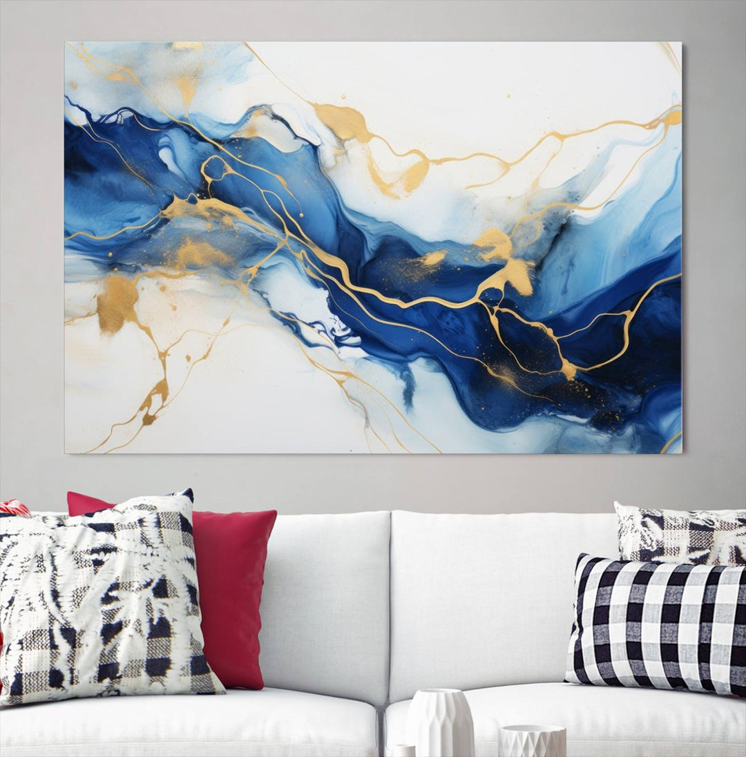 The Blue Abstract Wall Art is displayed as a triptych on museum-quality canvas, showcasing a blue and gold abstract design. The artwork includes a UV-protective coating to maintain its vibrancy and comes with the benefit of free shipping.