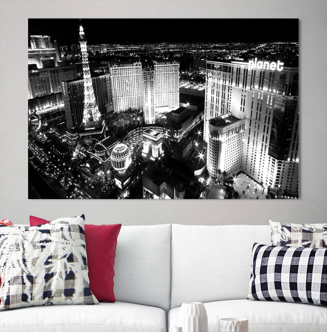 The Las Vegas Wall Art Canvas Print is a black and white triptych that showcases a city skyline at night. Crafted on museum-quality canvas with a UV-protective coating, it serves as an elegant and ready-to-hang focal point in the room.