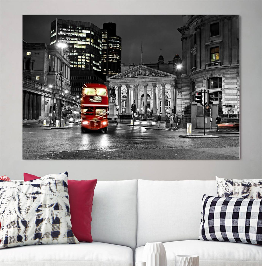 The London Night Red Bus Wall Art Canvas Print features a black and white cityscape with a moving red double-decker bus, crafted on museum-quality canvas with a UV-protective coating. This ready-to-hang artwork is designed to stand out and enhance any space.