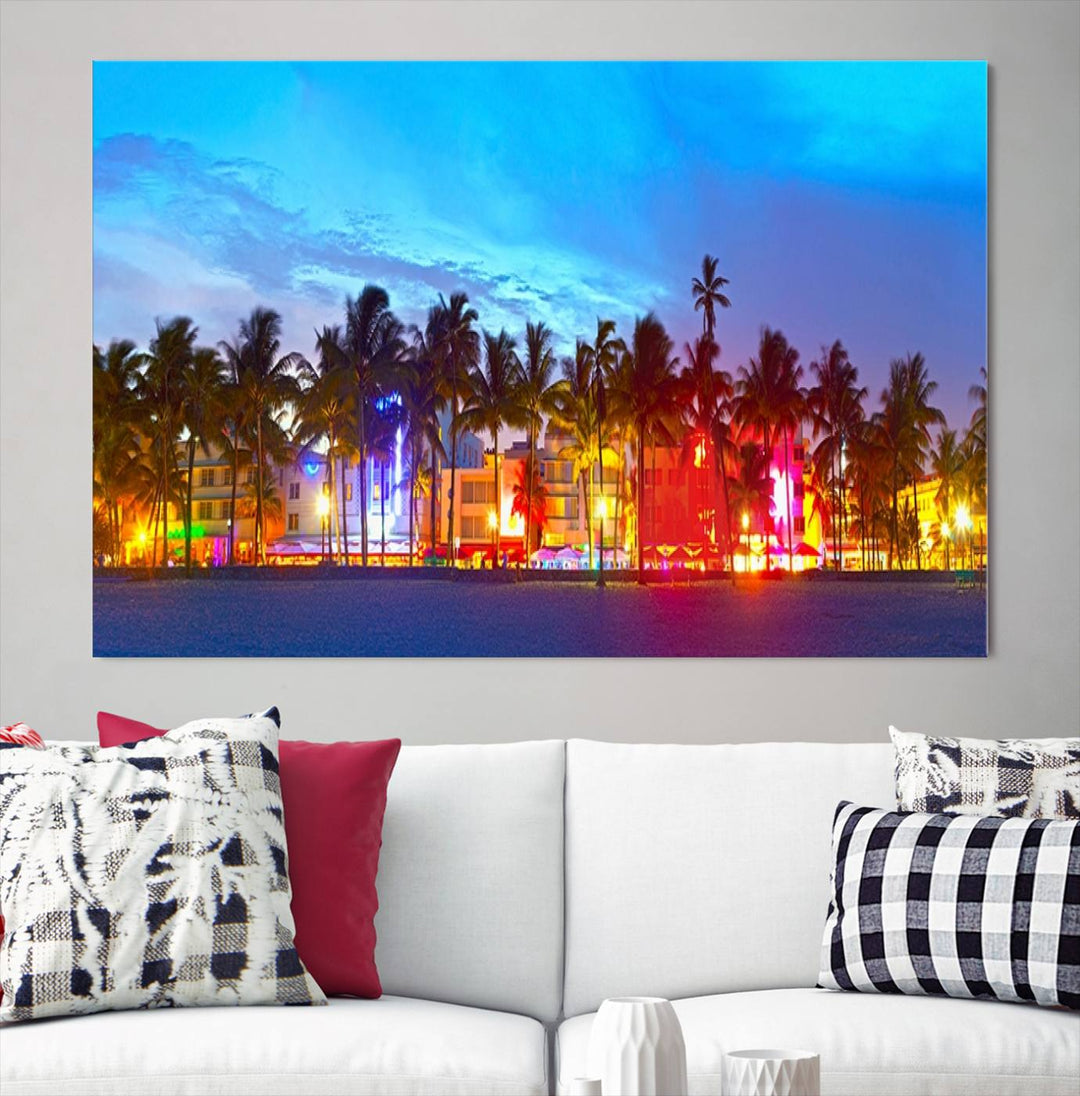 The living room features a three-panel Miami City Wall Art Canvas Print, showcasing a colorful, illuminated beach scene with palm trees on museum-quality canvas.