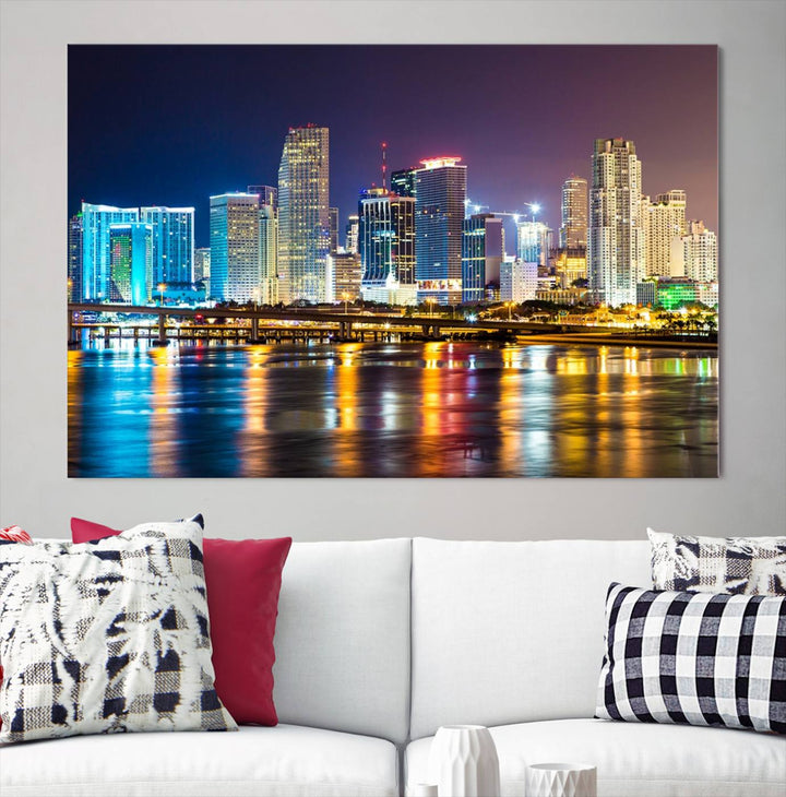 A stunning Miami City Wall Art Canvas Print on museum-quality canvas depicts a vibrant cityscape at night with colorful reflections.