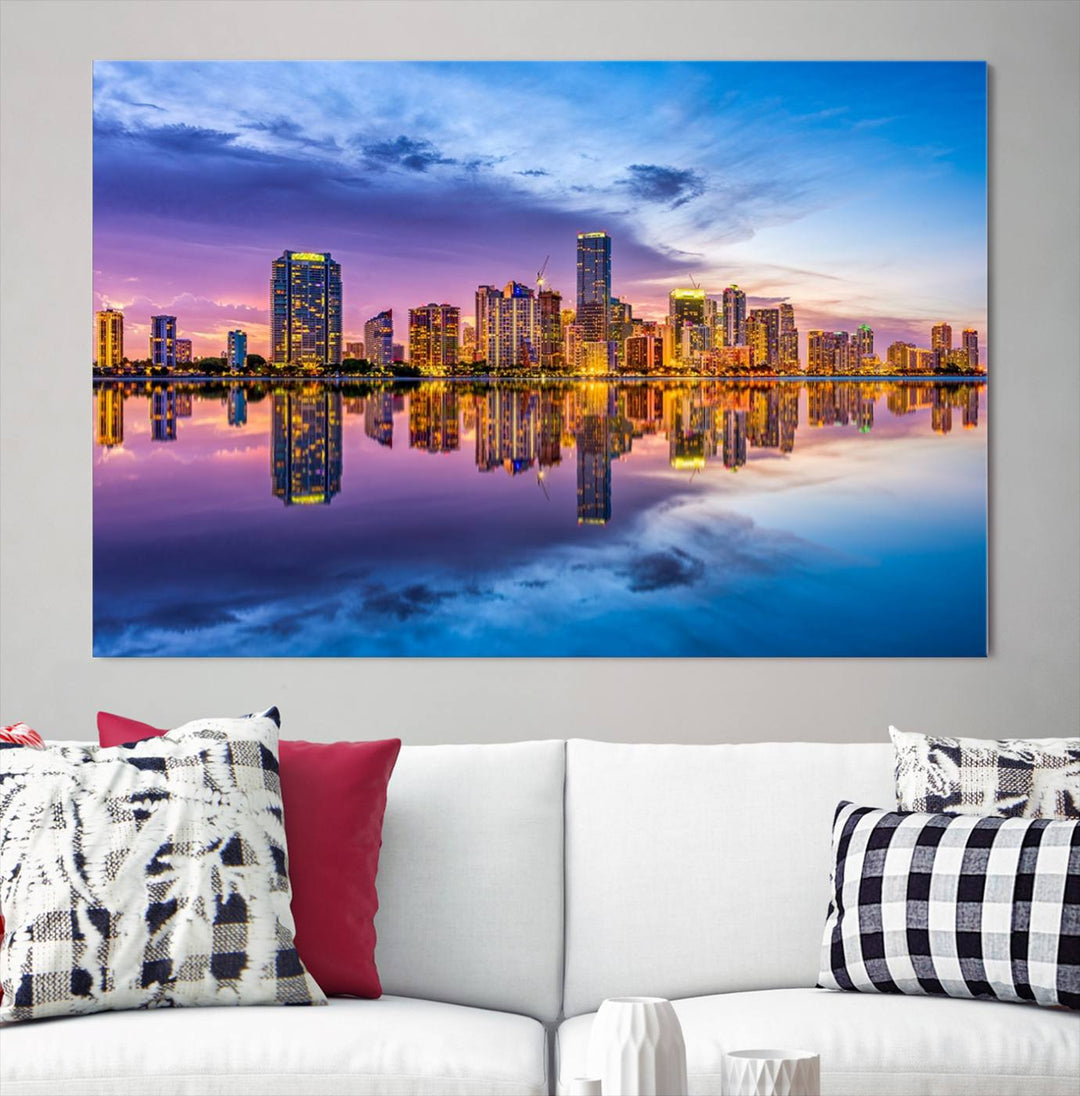 The Miami City Wall Art Canvas Print, featuring a three-panel depiction of a city skyline at sunset reflected in water, beautifully enhances the wall. Made with museum-quality canvas and a UV-protective coating, it comes ready to hang.