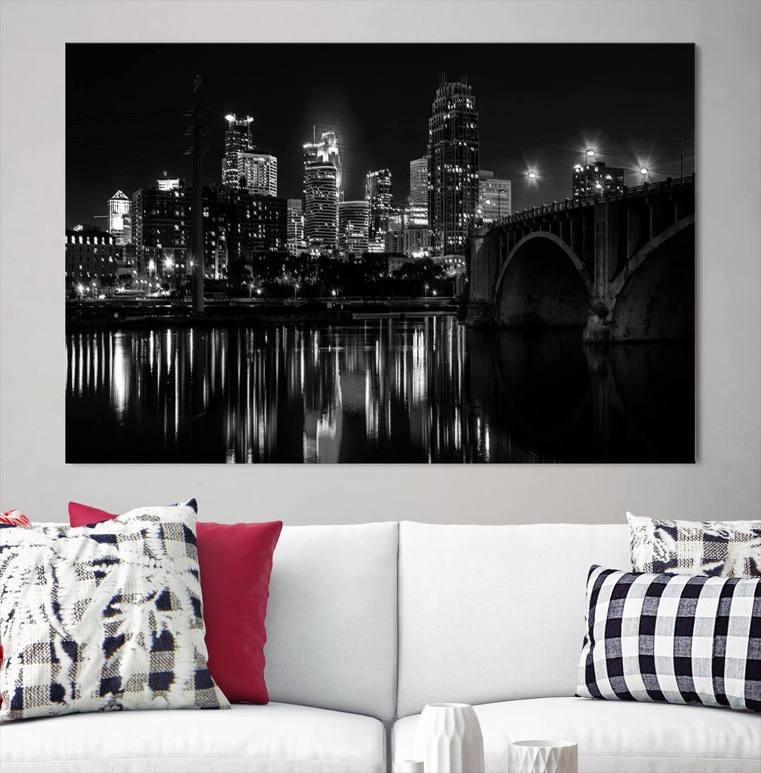 The "Minneapolis Wall Art Canvas Print, Minnesota City Wall Art Print, Minnesota Cityscapes Wall Art" features a black and white triptych of a city skyline with a bridge. Crafted on museum-quality canvas, this gallery-wrapped artwork is finished with a UV-protective coating to ensure lasting beauty.