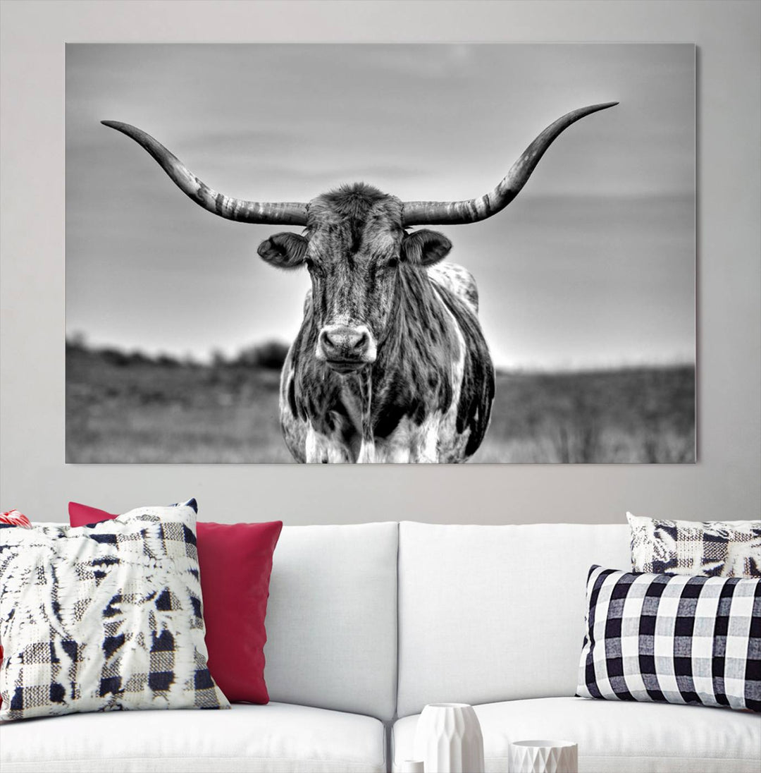 The Texas Longhorn Cow Wall Art, featuring a black and white image of a longhorn bull on canvas, brings charm to the room with its sophisticated appeal.