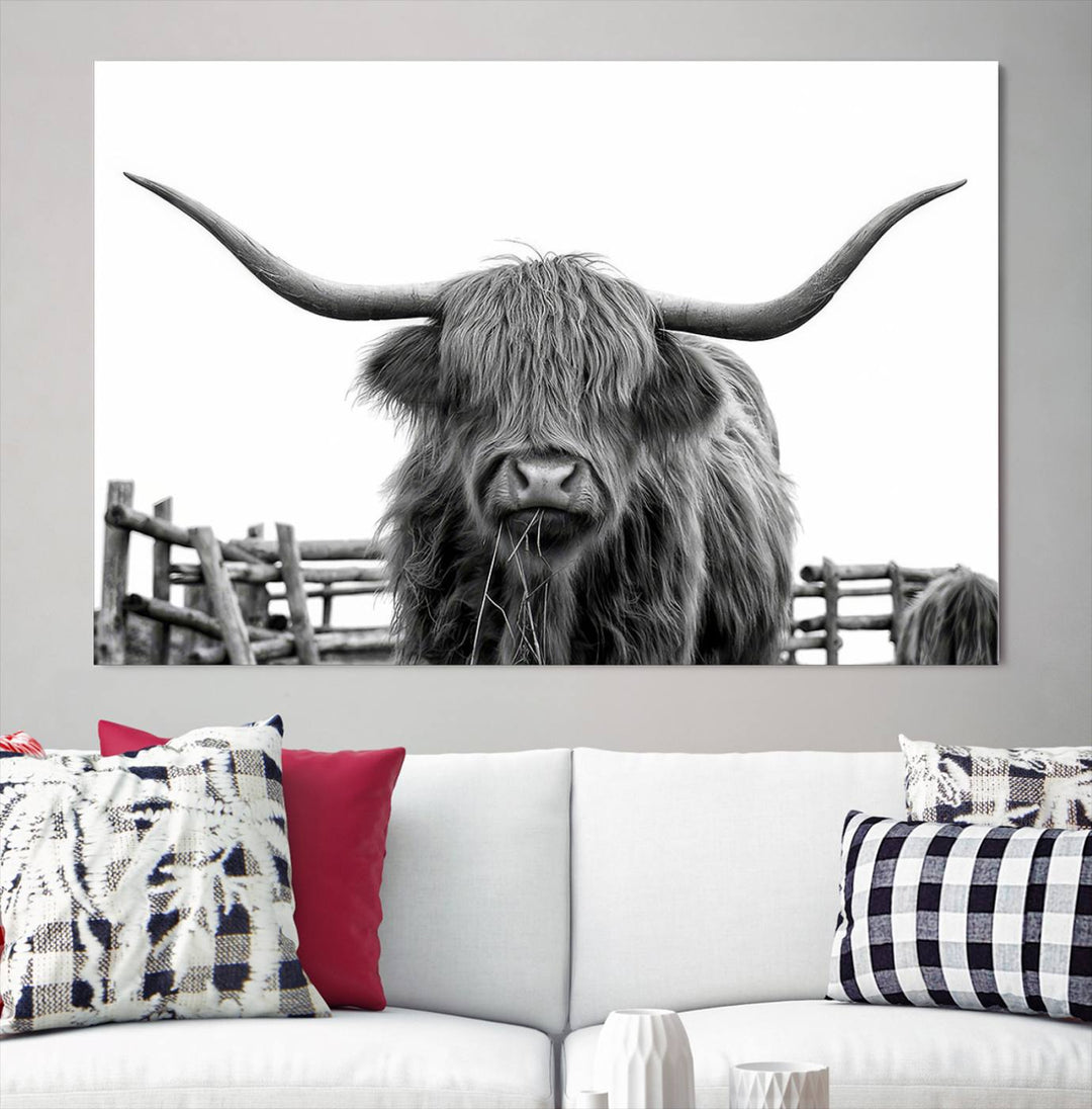 The Longhorn Canvas Print, featuring a black-and-white triptych of a Bighorn cow with shaggy fur and impressive long horns, is elegantly showcased. This wall art piece boasts a gallery-quality finish on premium canvas, bringing sophistication to any room.