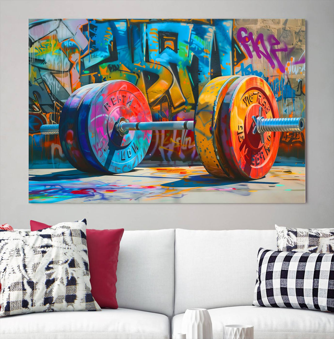 The Fitness Gym Barbell Graffiti Wall Art Canvas Print, a vibrant triptych featuring a barbell against a graffiti backdrop, elegantly hangs in the room. Crafted on premium canvas with a gallery-quality finish, this stunning piece of wall art effortlessly combines urban flair with sophisticated decor.