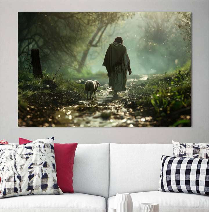 The wall art piece, titled "Jesus Shepherd a Lost Lamb Canvas Wall Art Print," is suspended on the wall and depicts a robed figure and a lamb wandering along a forest path.