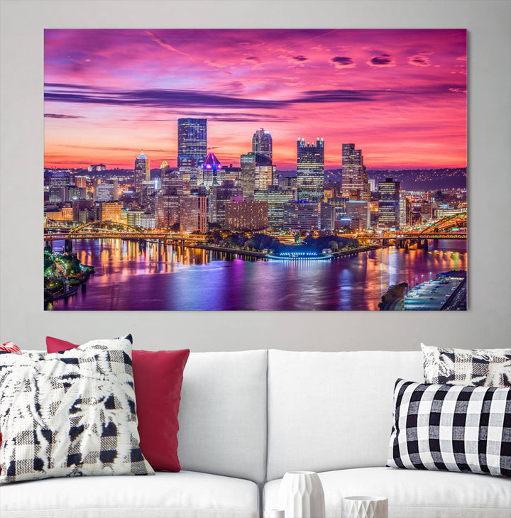 The Pittsburg Wall Art Canvas Print, showcasing a vibrant sunset glow over the city skyline and crafted by a professional artisan, adorns the space.