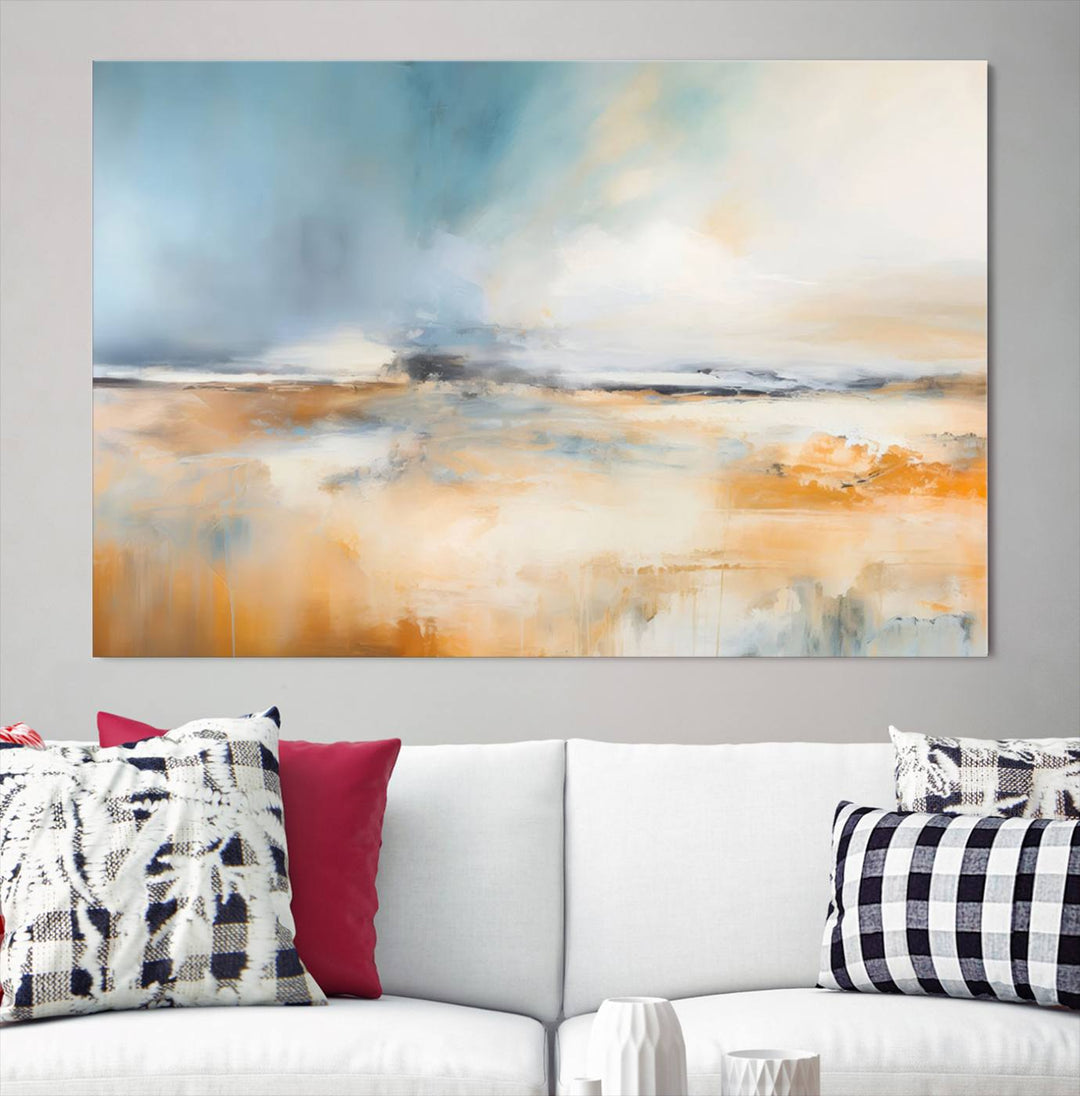 The Abstract Landscape Wall Art Canvas Print, featuring warm tones of orange and blue, is displayed on a dark wall.