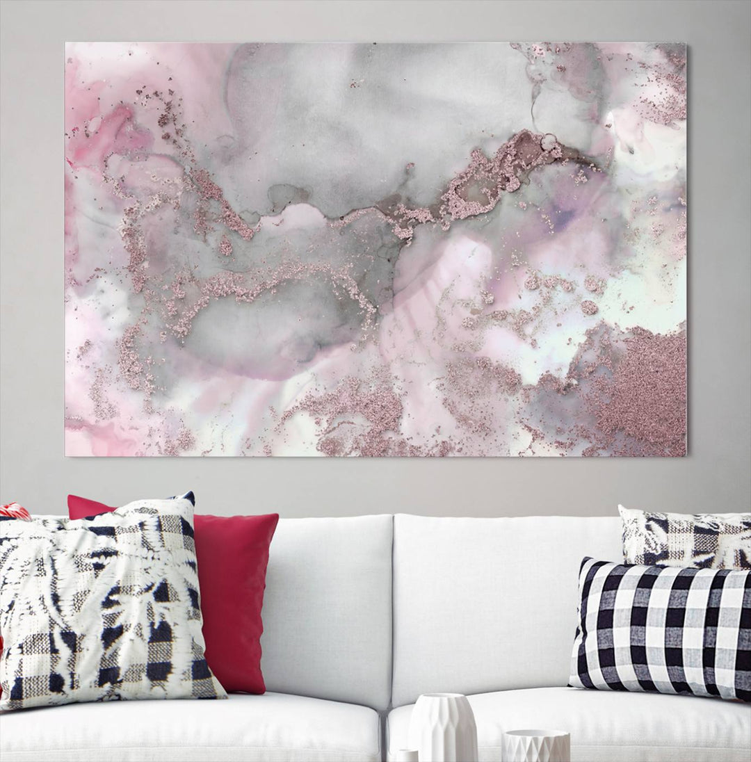 The Rose Marble Abstract Wall Art Canvas Print is a stunning triptych that showcases pink and gray tones, elegantly presented on a dark wall.