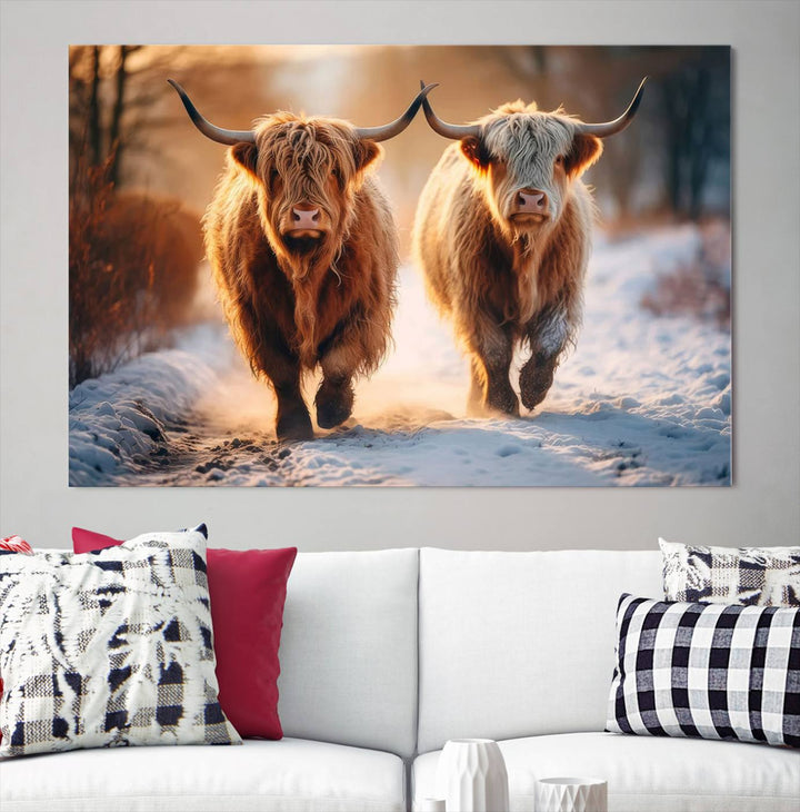 The living room showcases a triptych from the Scottish Highland Cow Horn Farm Wall Art Canvas Print collection, depicting two Highland cows running in the snow. Complementing this are handmade wall art pieces with a gallery-quality finish that add an elegant touch.