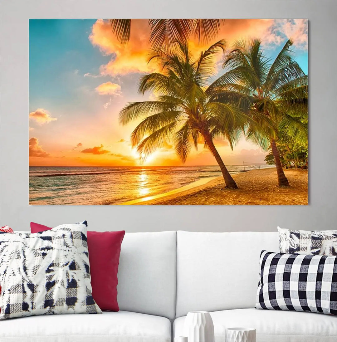 The Tropical Sunset Wall Art Print features a vibrant beach scene with palm trees and an ocean view highlighted by a golden sunset.